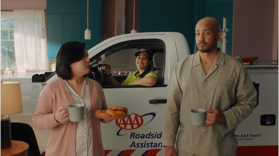 Couple in pjs with AAA truck in the background