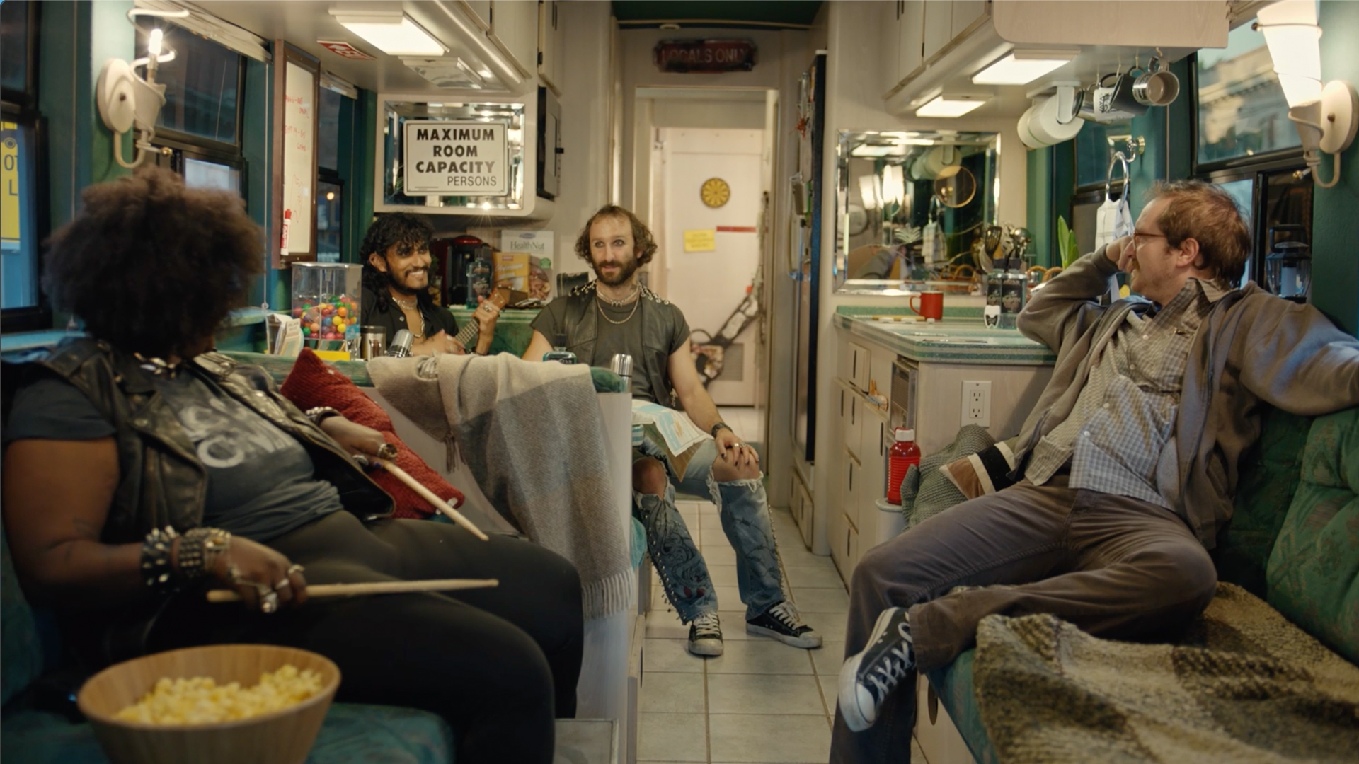 group of people sitting in a kitchen